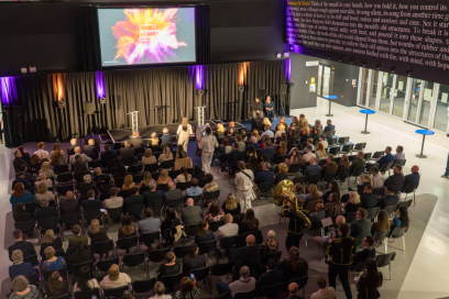 Attendees sat while KILNE band plays around them